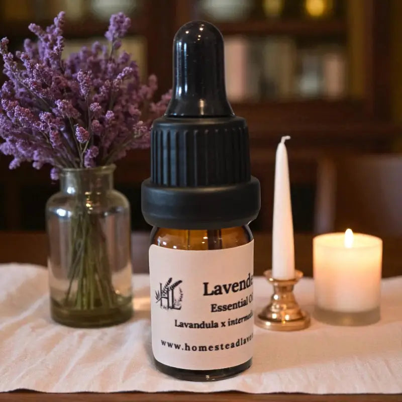 Amber bottle of 100% pure, steam-distilled lavender oil (5ml), with dropper and fresh lavender, made at Homestead Lavender Farm.