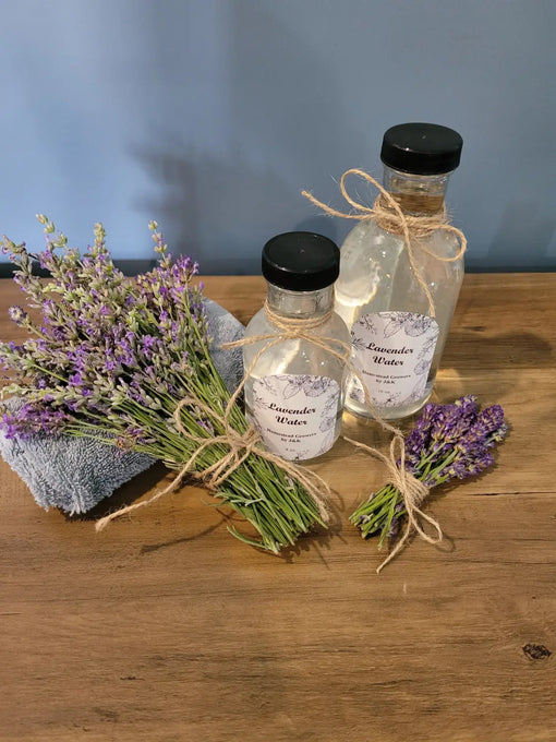 2 bottles of hydrosol with sprays of lavender beside them.