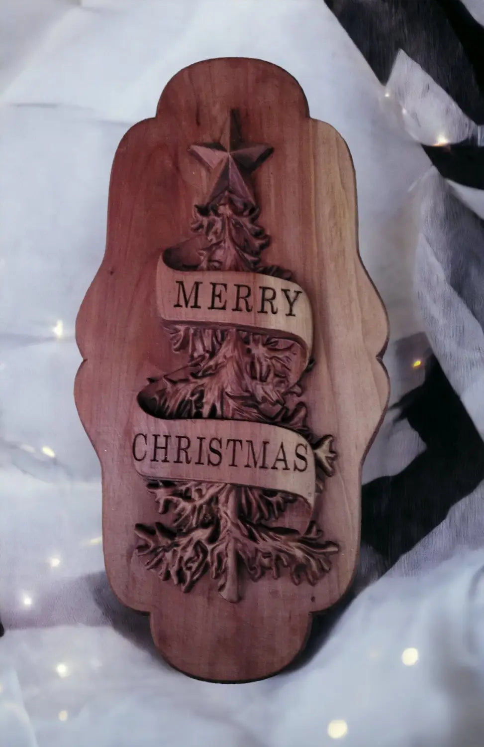 Small plaque with the words Merry Christmas carved into a banner wrapped around a cnc carved christmas tree.