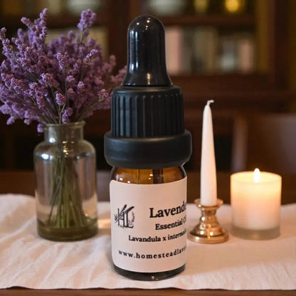 Amber bottle of 100% pure, steam-distilled lavender oil (5ml), with dropper and fresh lavender, made at Homestead Lavender Farm.