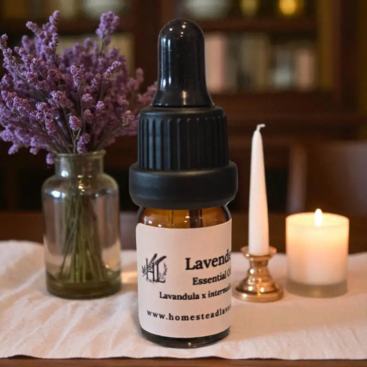 Amber bottle of 100% pure, steam-distilled lavender oil (5ml), with dropper and fresh lavender, made at Homestead Lavender Farm.