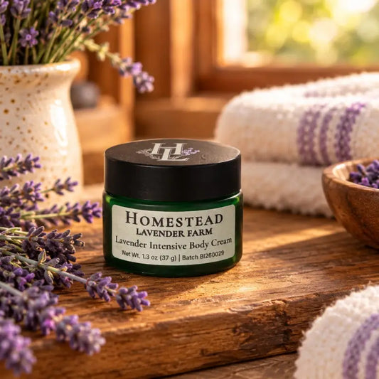 Lavender Intensive Body Cream in a green frosted glass jar on a wooden ledge with fresh lavender, Homestead Lavender Farm