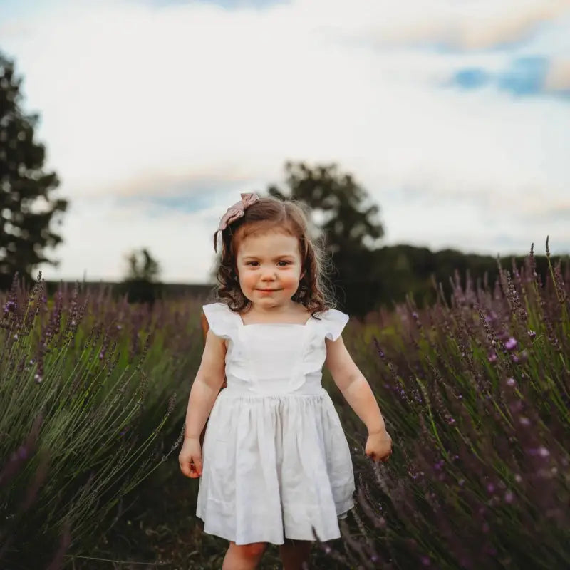 Young girl walking between the blooming lavender fields at Homestead Lavender Farm; first photography session on the farm.