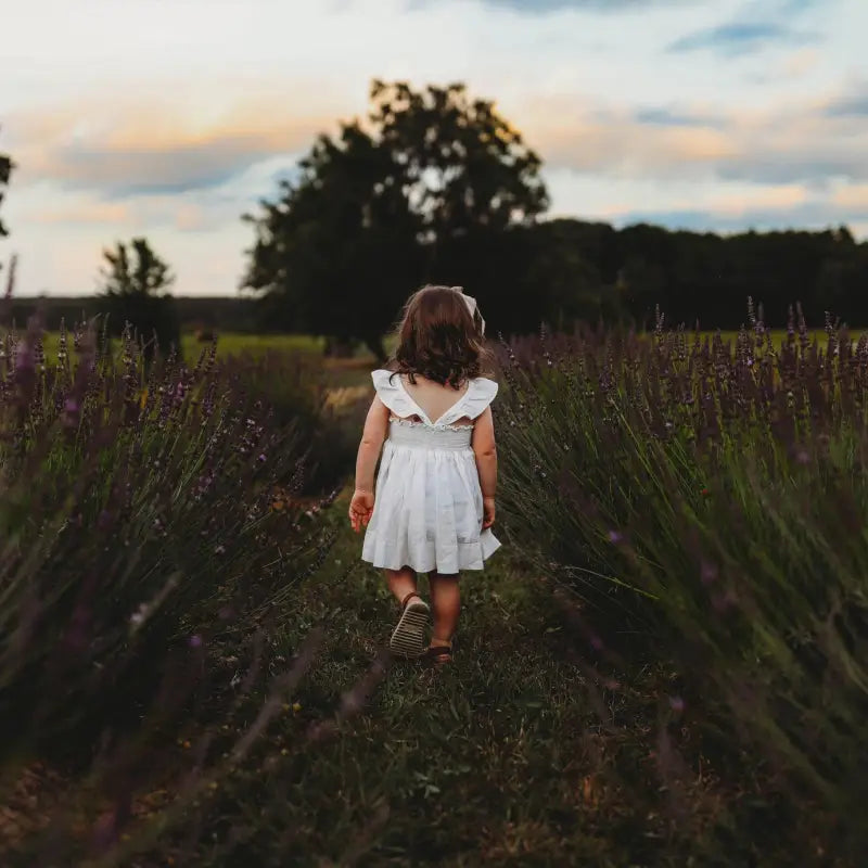 Young girl walking down the rows of the blooming lavender fields at Homestead Lavender Farm; first photography session on the farm.